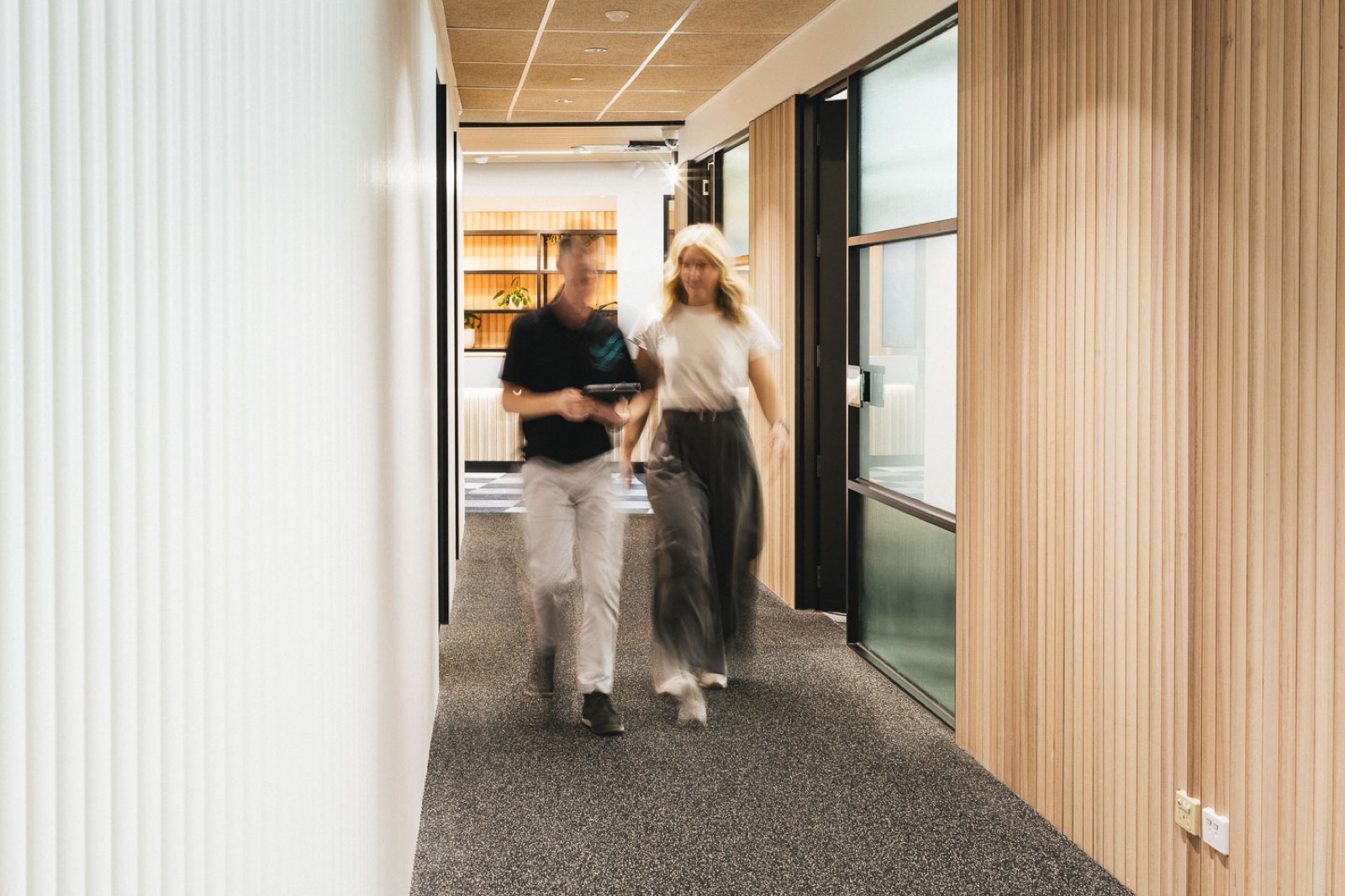 Performe clinician and patient walking through the clinic corridor