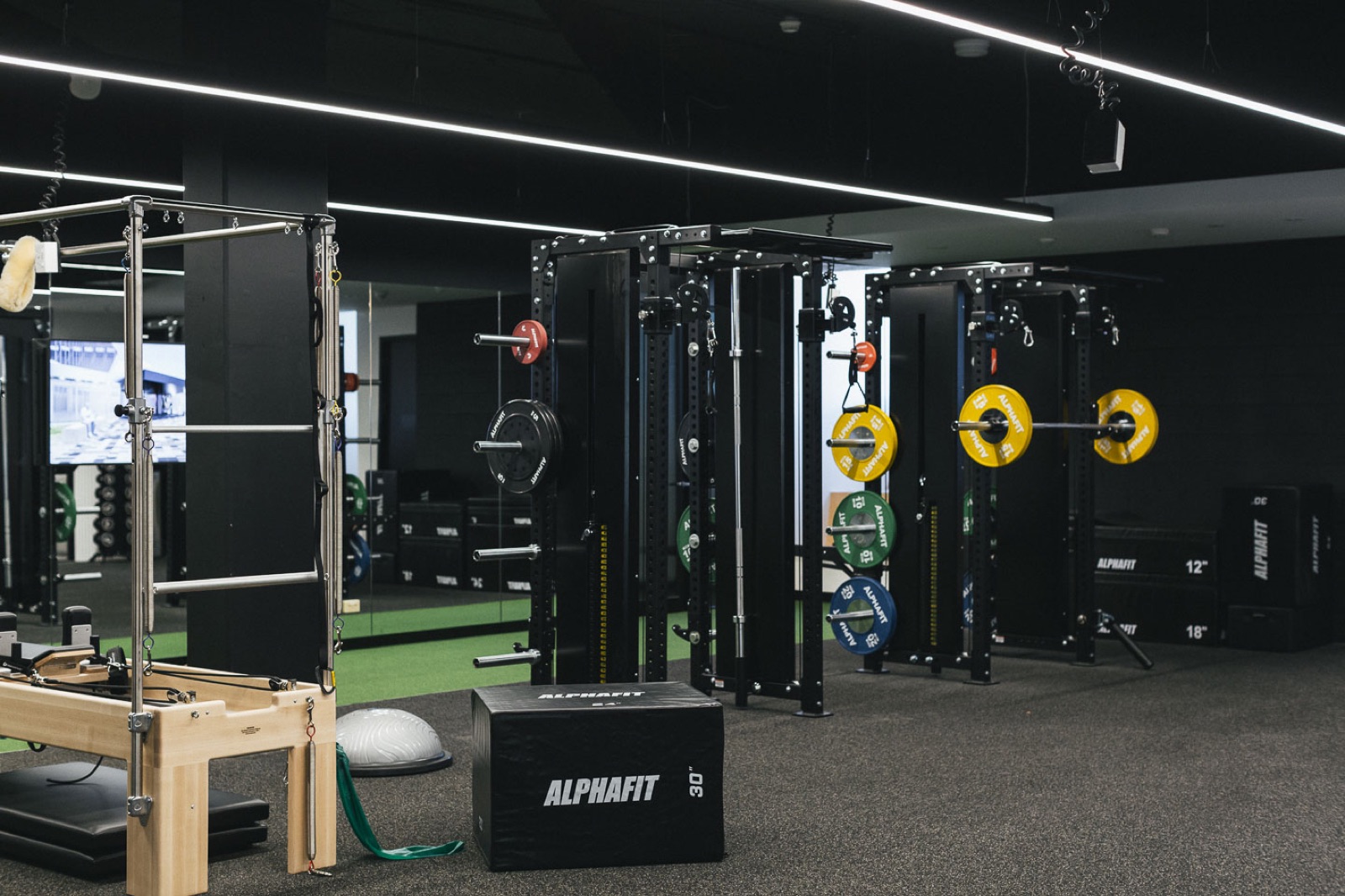 Performe Sports Medicine gym floor with strength training equipment and a Pilates reformer